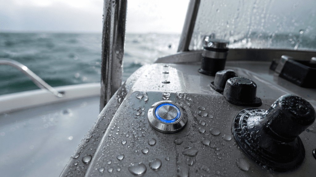 Waterproof metal push button switch on marine control panel